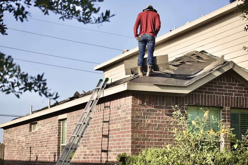 Professional roofer working on a residential roof in Eagles Loft